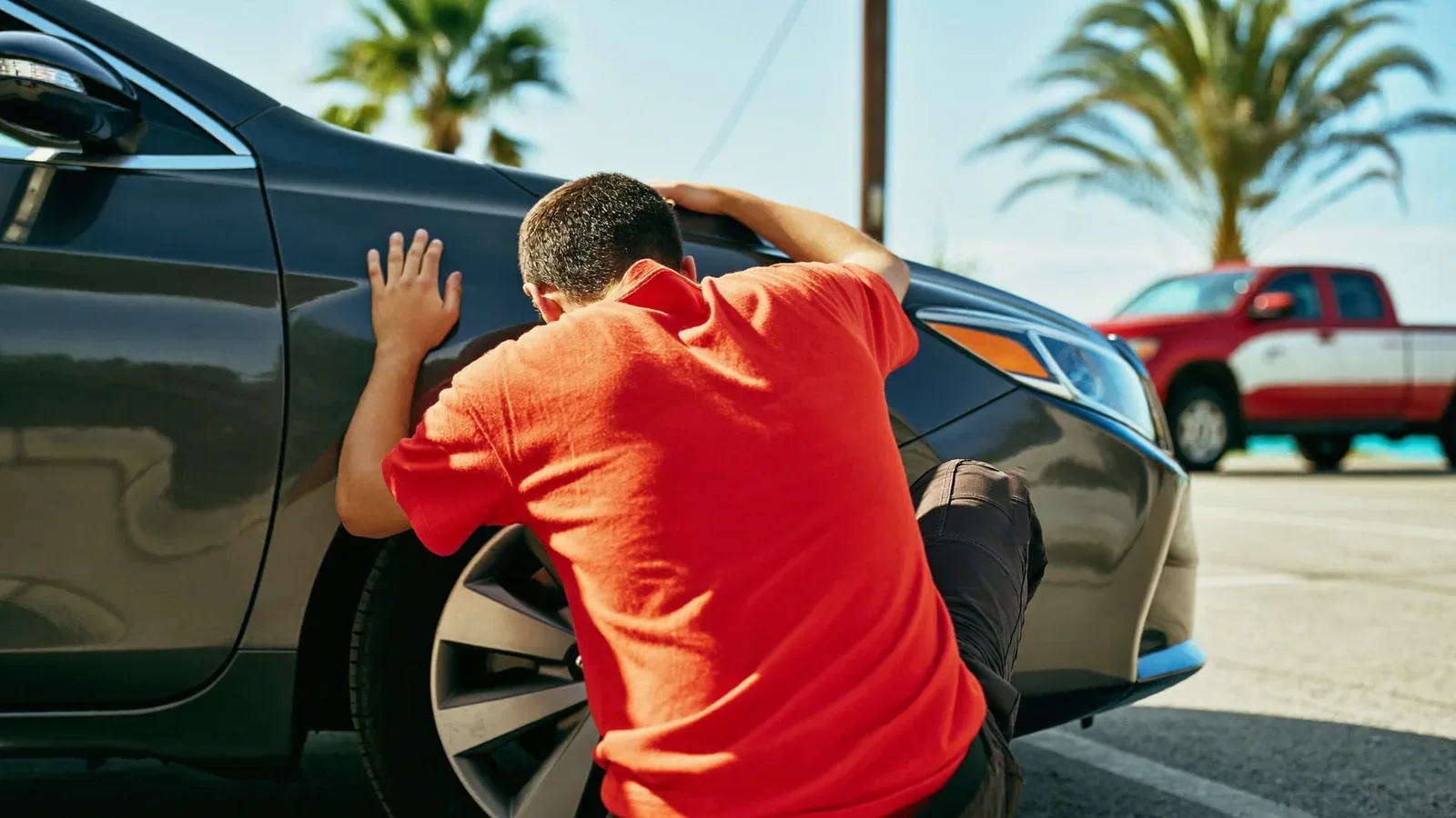 Leoserve crew member checking a car's wheel finish before a detail